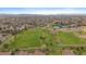 Expansive aerial view showcasing a beautiful park with athletic fields and walking paths surrounded by homes at 8615 W Berry Ave # 204, Littleton, CO 80123