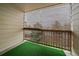 Cozy balcony with an outdoor privacy shade and artificial turf, ideal for relaxing or entertaining at 8615 W Berry Ave # 204, Littleton, CO 80123