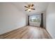 Bright, airy bedroom features a large window with views of the yard and attractive ceiling fan with light at 8615 W Berry Ave # 204, Littleton, CO 80123