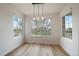 Sun-filled dining room with large windows offering pleasant views, enhanced by modern pendant lighting at 8615 W Berry Ave # 204, Littleton, CO 80123