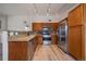 Well-lit kitchen features stainless steel appliances, light wood floors, granite countertops and attractive mosaic backsplash at 8615 W Berry Ave # 204, Littleton, CO 80123