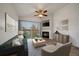 Cozy living room showcasing a fireplace, balcony access, and contemporary furnishings at 8615 W Berry Ave # 204, Littleton, CO 80123