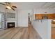Inviting living area featuring a fireplace and hardwood floors, next to an open kitchen concept at 8615 W Berry Ave # 204, Littleton, CO 80123