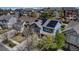 Aerial view of a blue house with solar panels, surrounded by lush trees and other residences at 25245 E Park Crescent Dr, Aurora, CO 80016