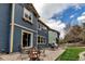 Backyard boasts a patio, fire pit, seating, lush green grass, and a well-maintained lawn at 25245 E Park Crescent Dr, Aurora, CO 80016