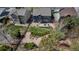 Aerial view of a backyard featuring a patio set, lush landscaping, and a wooden fence at 25245 E Park Crescent Dr, Aurora, CO 80016