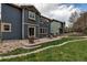 Cozy backyard area with patio seating, fire pit, and manicured lawn at 25245 E Park Crescent Dr, Aurora, CO 80016