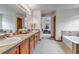 Bathroom featuring a double sink vanity, separate soaking tub and shower, and natural light at 25245 E Park Crescent Dr, Aurora, CO 80016