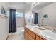 Bright bathroom featuring double sinks, a soaking tub, and modern fixtures, offering a clean and functional space at 25245 E Park Crescent Dr, Aurora, CO 80016