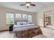 Comfortable bedroom with vaulted ceiling, a ceiling fan, a large bed, and bright natural light at 25245 E Park Crescent Dr, Aurora, CO 80016