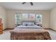 Bright bedroom with vaulted ceiling, a ceiling fan, a large bed with pillow saying, 