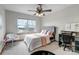 Well-lit bedroom with a window, bed, and vanity area, offering a comfortable and functional space at 25245 E Park Crescent Dr, Aurora, CO 80016