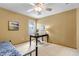 Bedroom with a large window, ceiling fan, and neutral walls, creating a serene and inviting atmosphere at 25245 E Park Crescent Dr, Aurora, CO 80016