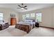 Comfortable bedroom with vaulted ceiling, a ceiling fan, a large bed, and bright natural light at 25245 E Park Crescent Dr, Aurora, CO 80016