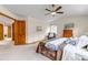 Bright bedroom with vaulted ceiling, a ceiling fan, a large bed, and an open door to hallway at 25245 E Park Crescent Dr, Aurora, CO 80016