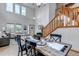 Charming dining area boasts a rustic table setting, a staircase, and lots of natural light at 25245 E Park Crescent Dr, Aurora, CO 80016