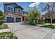 Charming exterior showcasing a blue-paneled and stone facade, two-car garage, welcoming porch, and neatly maintained lawn at 25245 E Park Crescent Dr, Aurora, CO 80016