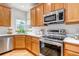 Modern kitchen featuring updated stainless steel appliances, light countertops, and hardwood floors at 25245 E Park Crescent Dr, Aurora, CO 80016