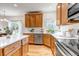 Well-appointed kitchen with stainless steel appliances, light countertops, and a view into the dining area at 25245 E Park Crescent Dr, Aurora, CO 80016