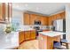Bright kitchen featuring stainless steel appliances, island with stool seating, and ample cabinet storage space at 25245 E Park Crescent Dr, Aurora, CO 80016