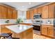 Modern kitchen with stainless steel appliances, plentiful counter space, and a center island with seating at 25245 E Park Crescent Dr, Aurora, CO 80016