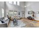 Bright living room showcases high ceilings, large windows, and modern decor at 25245 E Park Crescent Dr, Aurora, CO 80016