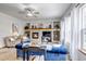 Inviting living room with a cozy fireplace, built-in shelving, and a comfortable blue sofa at 25245 E Park Crescent Dr, Aurora, CO 80016