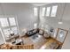 Open-concept living room with high ceilings, large windows, and modern furnishings at 25245 E Park Crescent Dr, Aurora, CO 80016