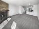 Open-concept living area showcasing a stone fireplace and seamlessly connected kitchen with island seating at 1622 S Idalia Cir # G, Aurora, CO 80017