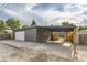 Back exterior of home with covered parking and a one-car garage at 1640 Iola St, Aurora, CO 80010