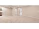 Open basement living space features neutral carpet and leads to a bathroom at 1640 Iola St, Aurora, CO 80010