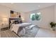 Serene bedroom featuring neutral tones, patterned accents, and a large window at 1640 Iola St, Aurora, CO 80010