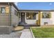 Home featuring a charming front entry and well manicured front yard at 1640 Iola St, Aurora, CO 80010