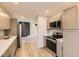 Modern kitchen featuring stainless steel appliances and stylish cabinetry at 1640 Iola St, Aurora, CO 80010