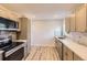 Updated kitchen featuring stainless steel appliances, quartz countertops, and stylish fixtures at 1640 Iola St, Aurora, CO 80010