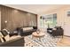 Cozy living room showcases a unique accent wall, natural light, and comfortable seating at 1640 Iola St, Aurora, CO 80010