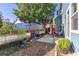 Backyard featuring a raised garden bed, patio, and mature tree at 427 S Parkside Dr, Longmont, CO 80501