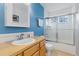 Bathroom featuring a tiled shower, toilet, and a single sink vanity at 427 S Parkside Dr, Longmont, CO 80501