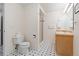 Bathroom featuring black and white tiled floor, shower, toilet, and vanity at 427 S Parkside Dr, Longmont, CO 80501
