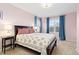 Bedroom with pink walls, carpet, and windows dressed with blue curtains at 427 S Parkside Dr, Longmont, CO 80501
