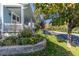 Landscaped front yard with a variety of plants and trees, and blue siding house at 427 S Parkside Dr, Longmont, CO 80501