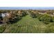 Expansive green lawn, freshly cut, surrounded by mature trees and mountain views in the background at 427 S Parkside Dr, Longmont, CO 80501