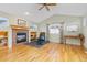 Living room with hardwood floors, a fireplace, and built-in shelving at 427 S Parkside Dr, Longmont, CO 80501