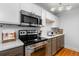 Updated kitchen with stainless steel appliances and white cabinets at 857 S Van Gordon E104 Ct # E104, Lakewood, CO 80228