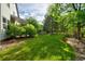 Lush green backyard with manicured lawn and mature trees creating a serene setting at 10356 Lions Heart, Lone Tree, CO 80124