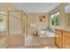 This well-lit bathroom features a glass shower, a soaking tub, and a vanity with bright, natural lighting at 10356 Lions Heart, Lone Tree, CO 80124