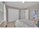 Cozy bedroom featuring double door closet with an open door to the ensuite at 10356 Lions Heart, Lone Tree, CO 80124
