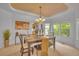 Cozy dining area with stylish furnishings, including a wood table and views of the landscaped yard at 10356 Lions Heart, Lone Tree, CO 80124