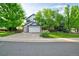 Charming two-story home with a well-manicured lawn and mature trees providing shade at 10356 Lions Heart, Lone Tree, CO 80124