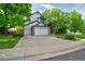 Charming two-story home with a well-manicured lawn and mature trees providing shade at 10356 Lions Heart, Lone Tree, CO 80124